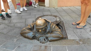 Statue qui sort du sol à Bratislava avec le casque qui porte bonheur j'ai oublié son nom